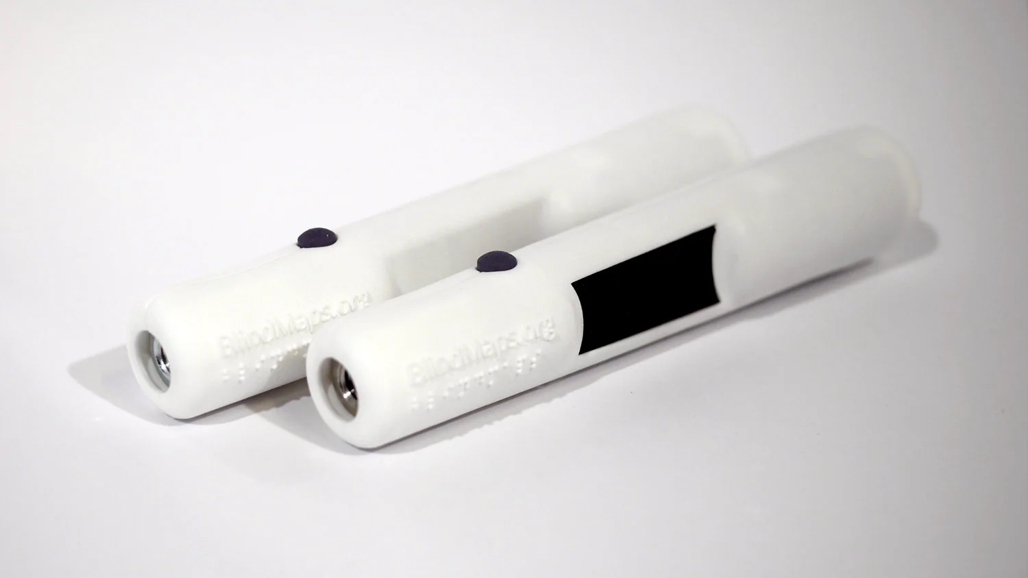 Two BlindMaps grip prototypes and their screw connection to a white cane